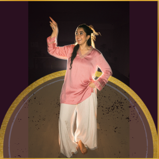 Ada Dance Singapore instructor mid-pose in a pink kurta